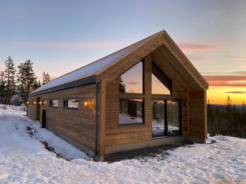 Moderna koka karkasa paneļu privātmāja Latvijā ar lieliem panorāmas logiem priekšējā fasādē